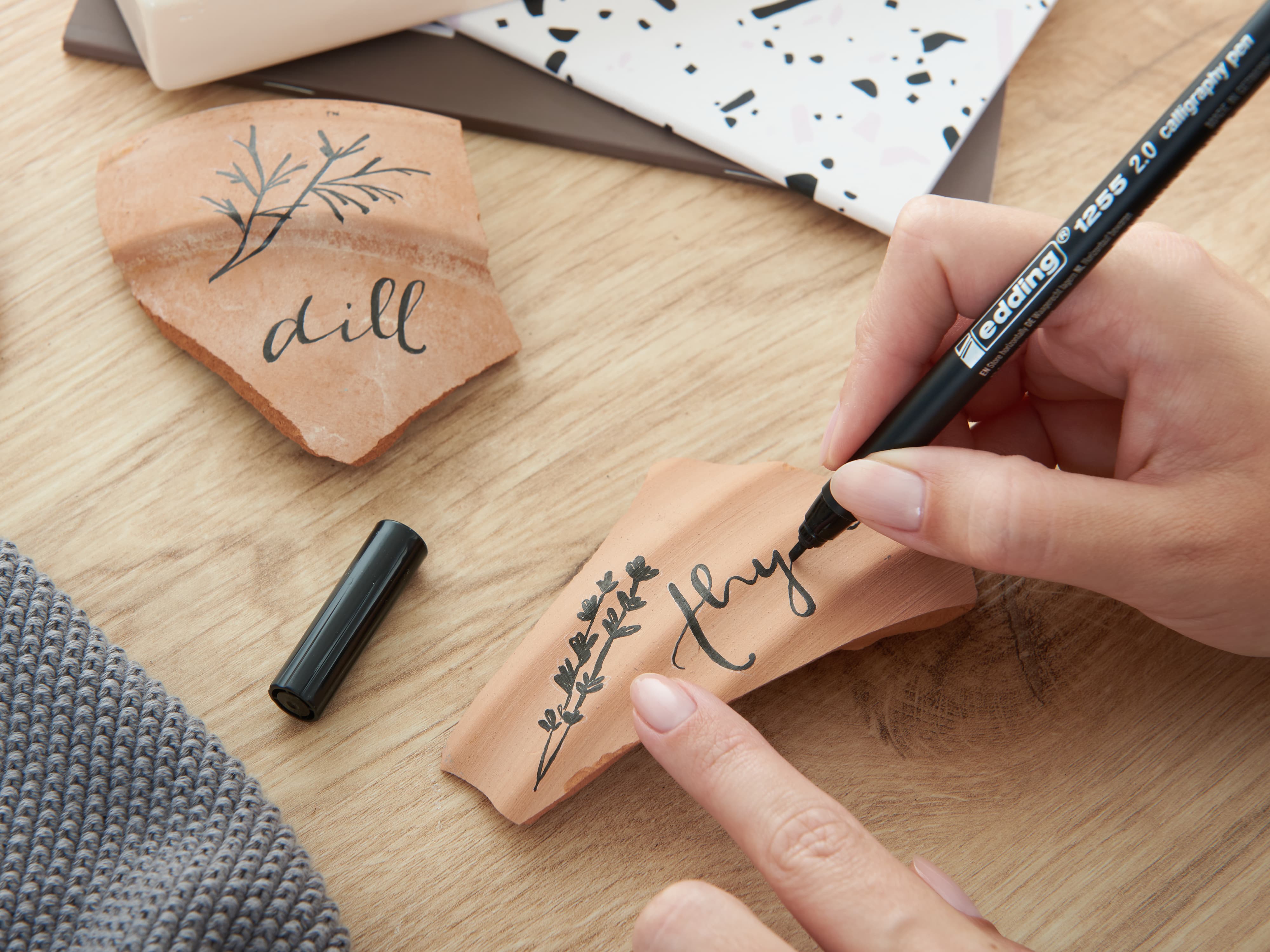 Tonscherbe wird als Kräterschild beschriftet