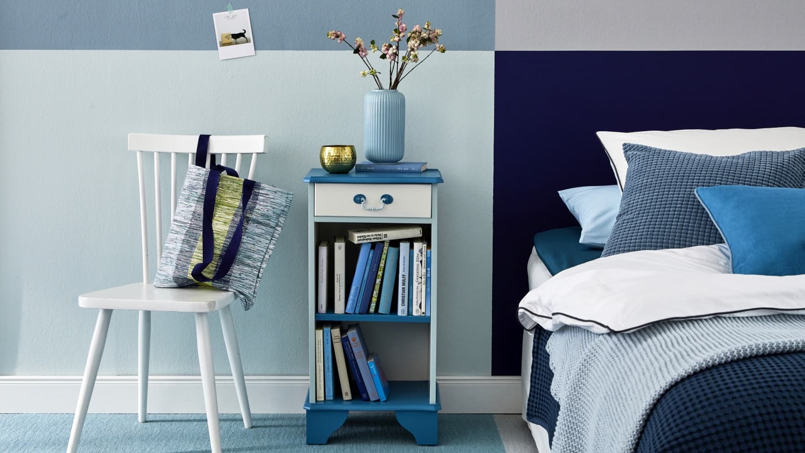 edding blau angemalter Nachttisch mit Büchern gefüllt in einem Schlafzimmer