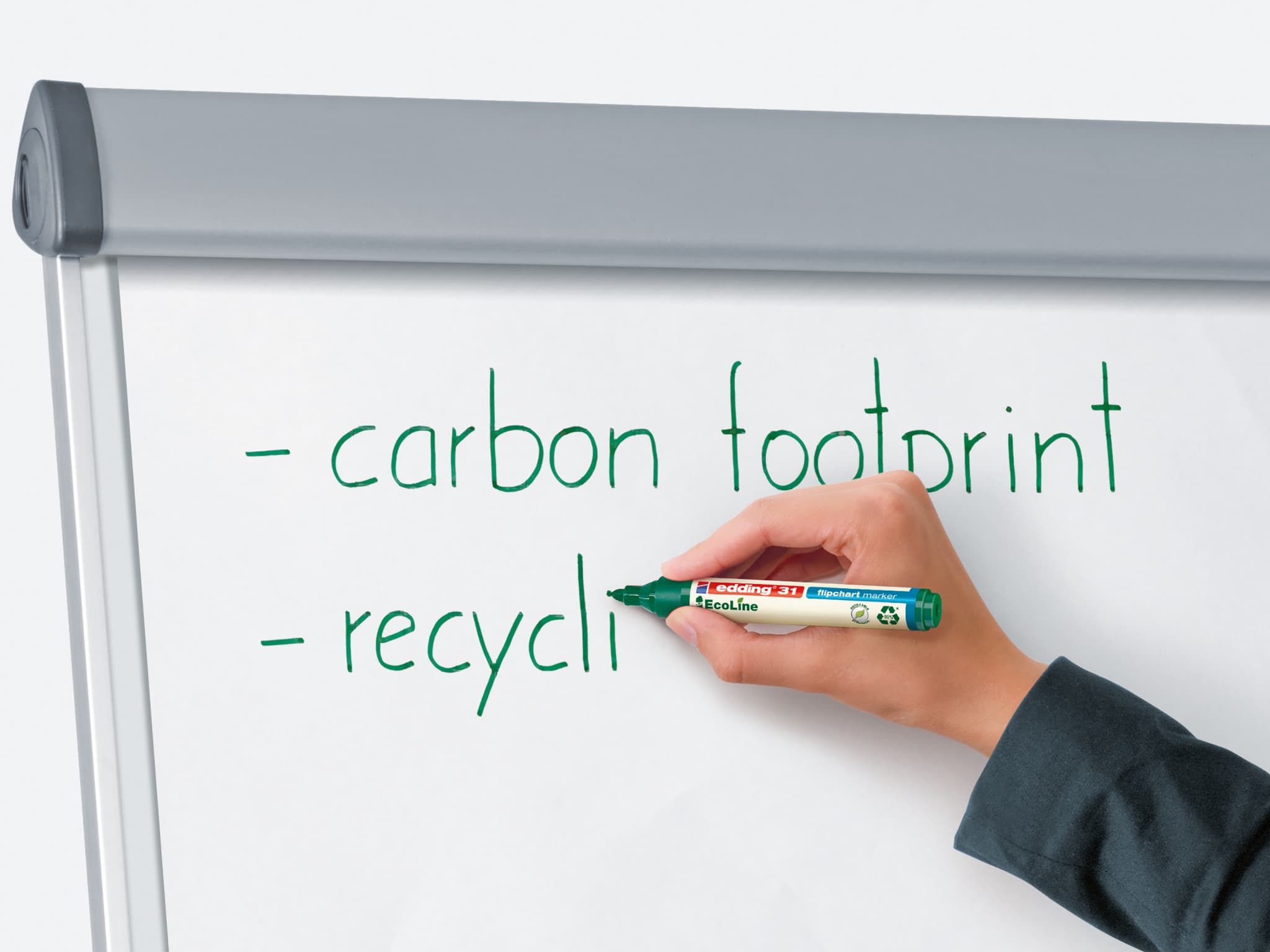 Eine Person schreibt mit einem edding 31 EcoLine Flipchartmarker 4er-Set eine Liste zum Thema ökologische Nachhaltigkeit mit den Begriffen „CO2-Fußabdruck“ und „Recycling“ auf einem Whiteboard.